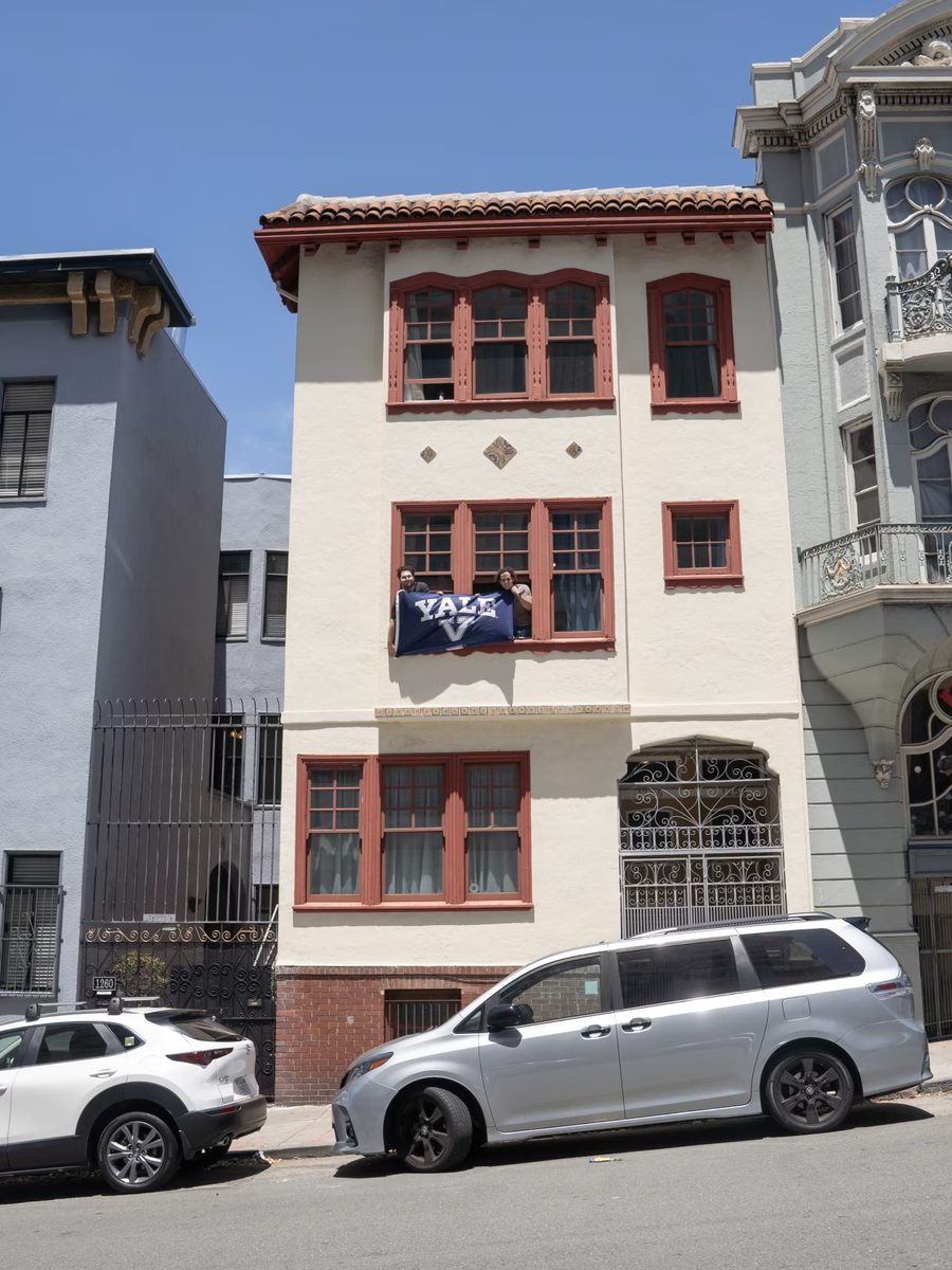 The Hacker House on Hyde Street, a Yale flag hung from a second-floor window.